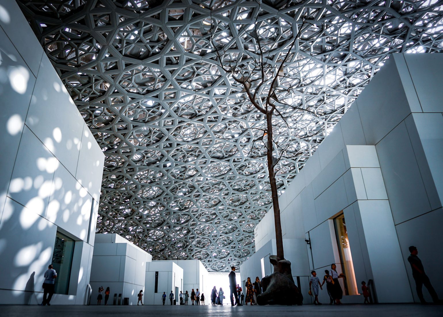 The interior of the huge silvery dome from the central atrium of Louvre Abu Dhabi.