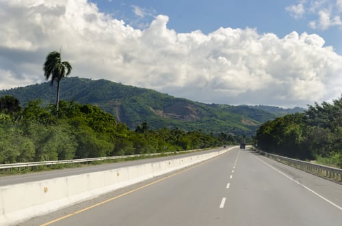 asphalt-highway-with-concrete-barrier-on-a-sunny-d-2023-11-27-05-36-38-utc