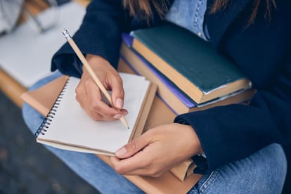 lady-in-spring-clothes-holding-books-on-her-knees-2021-09-03-22-33-32-utc