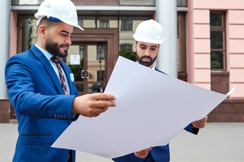 two-arab-architects-looking-at-the-plan-outdoors-2022-01-27-20-55-53-utc