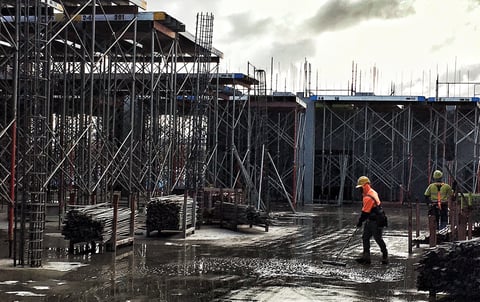 two-men-working-on-a-construction-site-surrounded-2022-11-17-15-42-56-utc